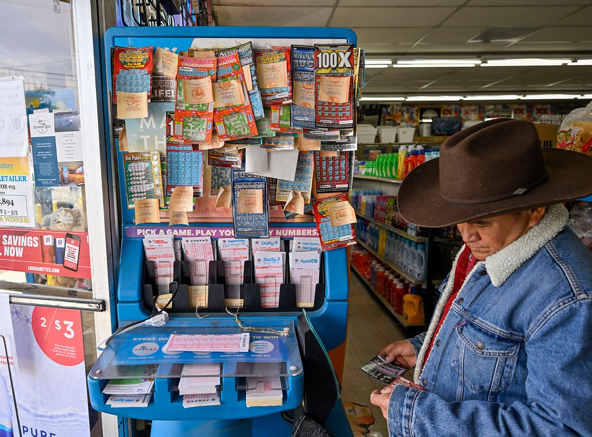 Powerball
Garden Grove, CA - November 02: Alberto Lara checks for winning scratchers at the lottery station inside ABC Liquor in Garden Grove, CA, on Wednesday, November 2, 2022. The Powerball prize soared to $1.2 billion after no winners were found Monday. (Photo by Jeff Gritchen/MediaNews Group/Orange County Register via Getty Images)