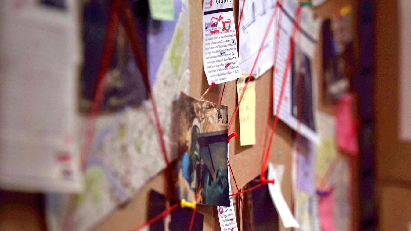 Investigation board with pinned photos, newspapers and notes, solving crime