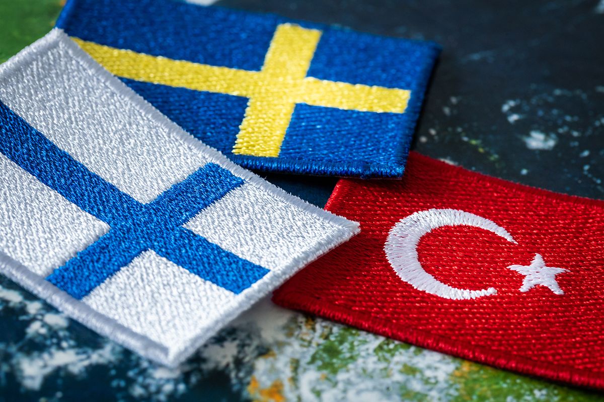 The Turkish flag next to the flags of Finland and Sweden. Concept of a political conflict between a member of the alliance and the candidates for membership
