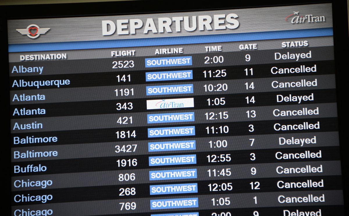 A departures screen shows flights cancelled or delayed after a shooting incident at Los Angeles International Airport (LAX) on November 1, 2013 after a gunman reportedly opened fire at a security checkpoint.  Police believe the gunman who opened fire at Los Angeles airport Friday acted alone, a police chief said, while not confirming reports that the shooter and one victim were killed. 
