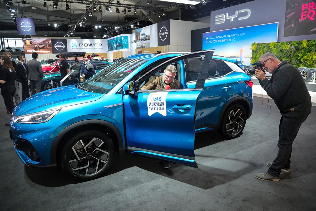BELGIUM-BRUSSELS-MOTOR SHOW (230114) -- BRUSSELS, Jan. 14, 2023 (Xinhua) -- Journalists make report on a BYD Atto 3 electric car during a media preview of the 100th Brussels Motor Show in Brussels, Belgium, Jan. 13, 2023. A fleet of luxury electric vehicles (EV) from Chinese manufacturers were showcased for the first time this week at the 100th Brussels Motor Show, which opened its doors to industry professionals and media on Friday.   TO GO WITH "Chinese EVs shine at 2023 Brussels Motor Show" (Xinhua/Zheng Huansong) (Photo by Zheng Huansong / XINHUA / Xinhua via AFP)