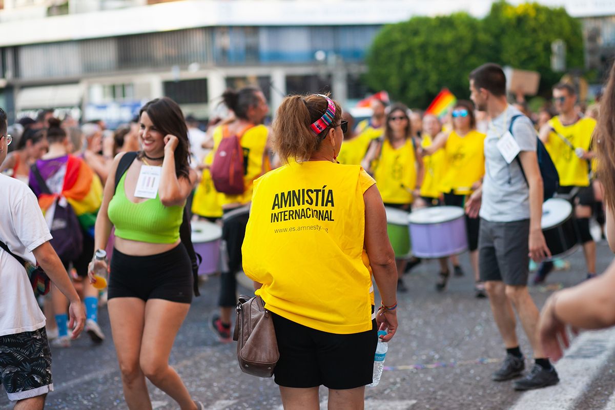 Amnesty,International,Workers,At,Pride,Parade,With,Rainbow,Flag,As