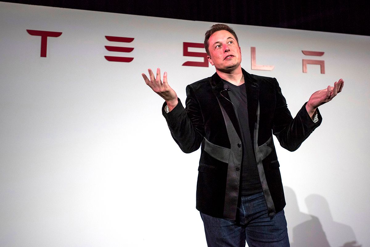 Tesla Motors Inc. Model X SUV Reveal Elon Musk, chairman and chief executive officer of Tesla Motors Inc., gestures as he speaks during a news conference prior to unveiling the Model X sport utility vehicle (SUV) during an event in Fremont, California, U.S., on Tuesday, Sept. 29, 2015. Musk handed over the first six Model X SUVs to owners in California Tuesday night, as Tesla reached a milestone of having two all-electric vehicles in production at the same time. Photographer: David Paul Morris/Bloomberg via Getty Images 
