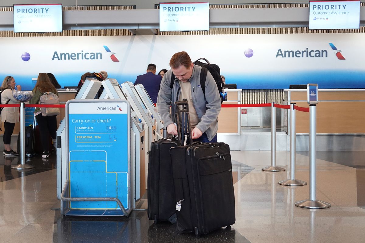 CHICAGO, ILLINOIS - OCTOBER 11: Passengers check in for an American Airlines flightsat O'Hare International Airport on October 11, 2022 in Chicago, Illinois. Citing a strong summer travel season, American Airlines said today that its third-quarter sales will likely be in better than expected despite higher costs. 