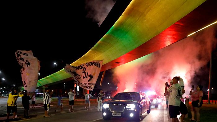SANTOS, BRAZIL - JANUARY 02: The hearse carrying Pele's coffin arrives to Santos as a firework goes off in the early morning ahead of the football legend's funeral in the stadium on January 02, 2023 in Santos, Brazil. Brazilian football icon Edson Arantes do Nascimento, better known as Pele, died on December 29, 2022 aged 82 after a battle with cancer in Sao Paulo, Brazil. The three-time World Cup champion with Brazil is considered one of the greatest football legends of all time. (Photo by Ricardo Moreira/Getty Images)