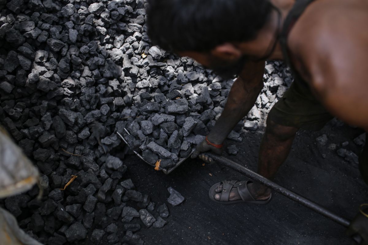 A worker loads coal into a sack at a coal wholesale market in Mumbai, India, on Thursday, May 5, 2022. Production of coal, the fossil fuel that accounts for more than 70% of Indias electricity generation, has failed to keep pace with unprecedented energy demand from the heat wave and the countrys post-pandemic industrial revival. 