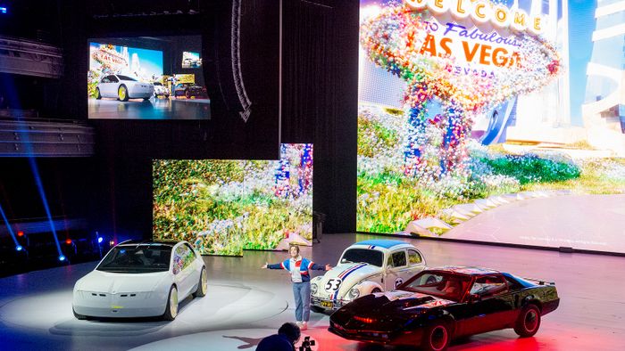 Technology Fair CES - BMW 04 January 2023, US, Las Vegas: At a keynote presentation by BMW at the technology trade show CES, the cars Herbie and Kitt, known from movies, can be seen on stage alongside the concept car "BMW i Vision Dee" and an actress. Photo: Andrej Sokolow/dpa (Photo by Andrej Sokolow/picture alliance via Getty Images)