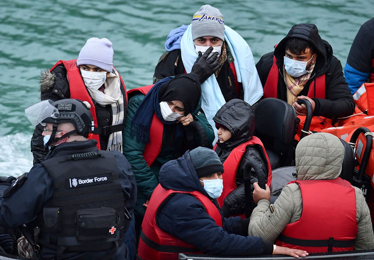 Migrants picked up at sea while attempting to cross the English Channel, are pictured on a UK Border Force patrol boat on arrival at the Marina in Dover, southeast England, on January 10, 2022. Last year, record numbers of more than 28,000 migrants who paid thousands of pounds to people traffickers arrived in the UK in often flimsy boats, according to analysis of Home Office data by the domestic Press Association news agency.
