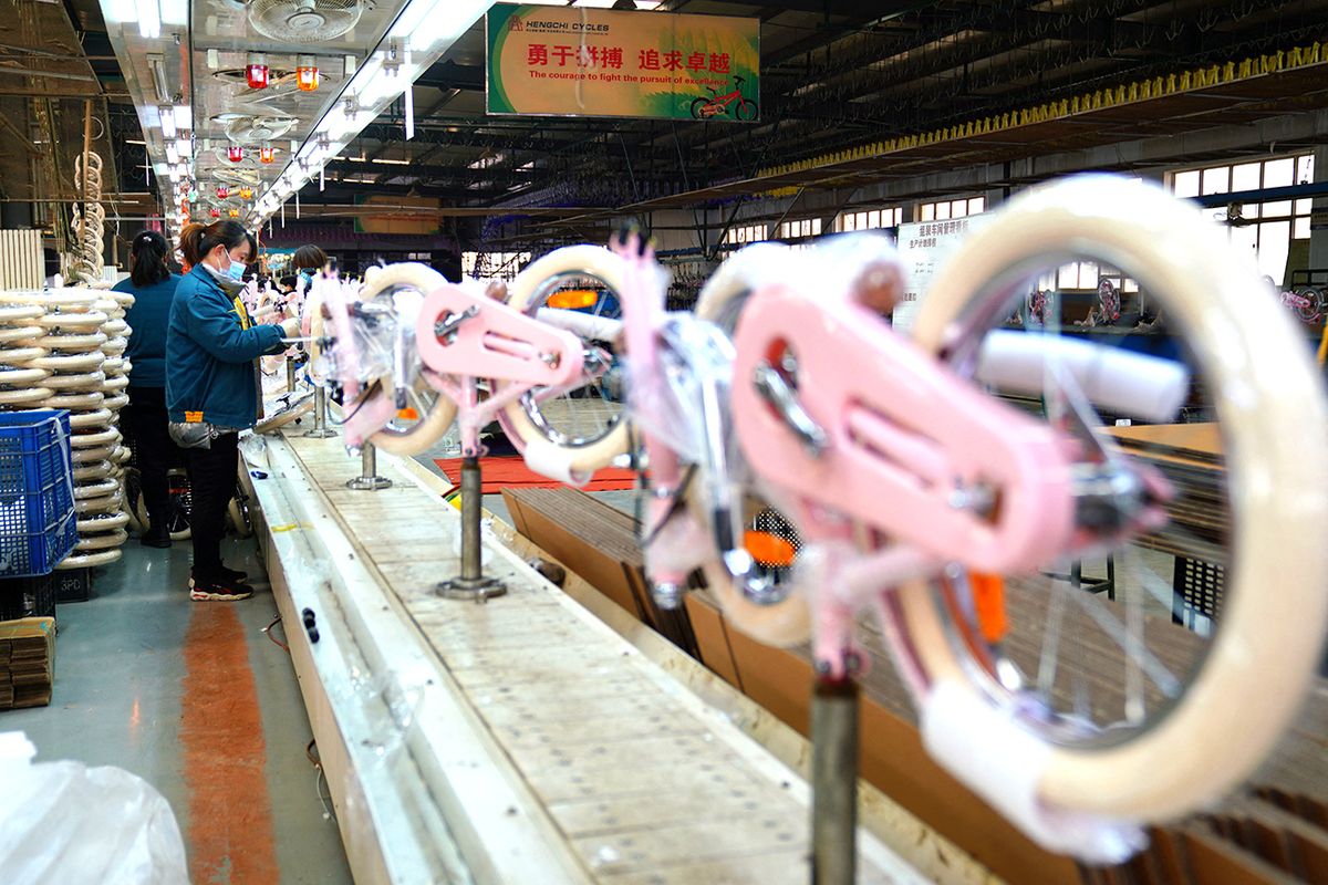 CHINA-HEBEI-PINGXIANG-BICYCLES-PRODUCTION (CN) (221227) -- PINGXIANG, Dec. 27, 2022 (Xinhua) -- Workers are seen busy on a production line at a factory of a bicycle and baby stroller manufacturer in Pingxiang County, north China's Hebei Province, Dec. 27, 2022. As the end of the year approaches, bicycle and baby stroller manufacturers in Pingxiang County of Hebei Province have stepped up production to guarantee the completion of orders from domestic and foreign customers. In recent years, Pingxiang County has been constantly promoting the high-quality development of bicycle and baby stroller manufacturing industry and actively snatching overseas market share. Its productions have been exported to over sixty countries and regions including Russia, Spain and Malaysia. (Xinhua/Mu Yu) (Photo by Mou Yu / XINHUA / Xinhua via AFP)