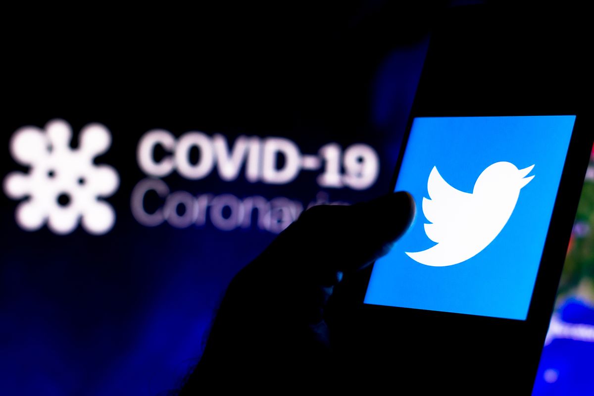 April,8,,2020,,Brazil.,In,This,Photo,Illustration,The,Twitter April 8, 2020, Brazil. In this photo illustration the Twitter logo seen displayed on a smartphone with a computer model of the COVID-19 coronavirus in the background.
