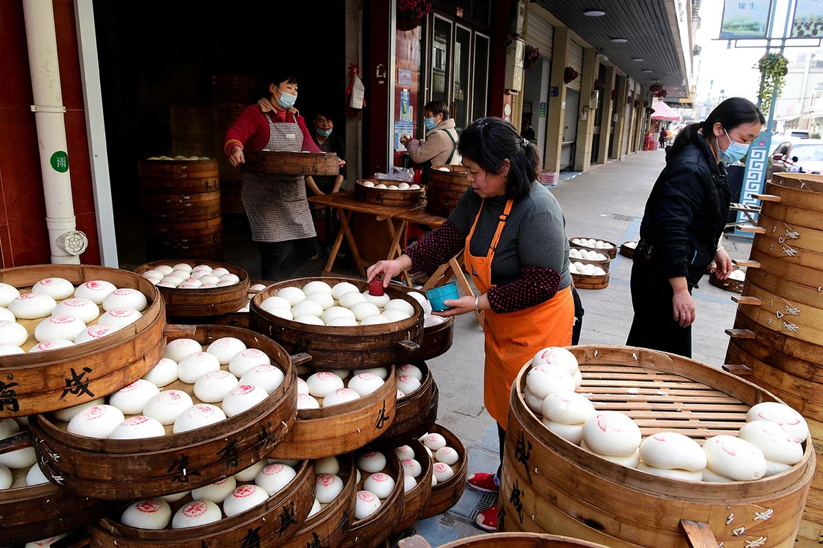 Chinese steamed buns welcome Spring Festival in Jinhua Workers are busy making "red printed steamed buns" in a Chinese steamed bun shop in Yafan Town, Wucheng District, Jinhua City, east China's Zhejiang Province, 11 January, 2023. (Photo by Shi Bufa / ImagineChina / Imaginechina via AFP)