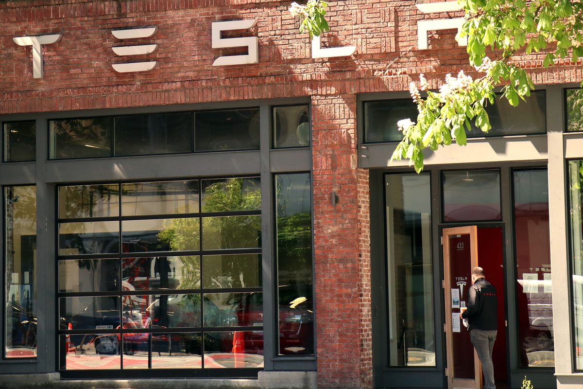 SEATTLE, UNITED STATES - 2021/04/26: A man enters the showroom of a Tesla dealership.Tesla announced its Q1 2021 earnings today. 