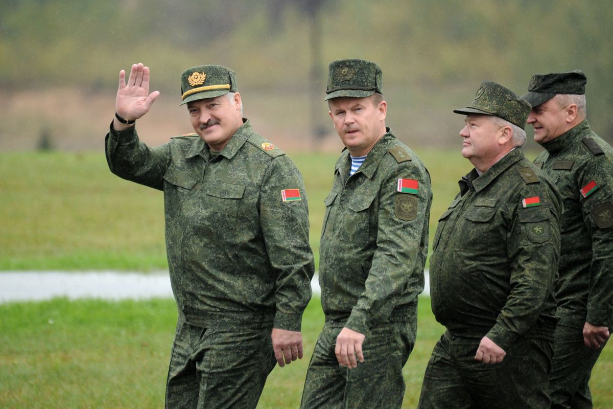 Belarus' President Alexander Lukashenko (L) waves as he arrives to inspect the joint Russian-Belarusian military exercises Zapad-2017 (West-2017) at a training ground near the town of Borisov on September 20, 2017. 