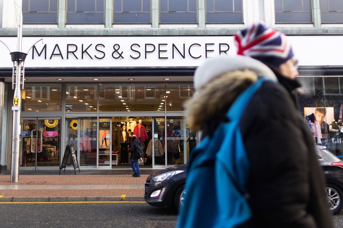 Shoppers pass a Marks and Spencer Group Plc retail store on the high street in Southend-on-Sea, UK, on Wednesday, Dec. 21, 2022. Brexit has left the UK economy 5.5% smaller than it would have been and added to the squeeze on public services thats behind strikes crippling the railways and National Health Service, a prominent research group concluded