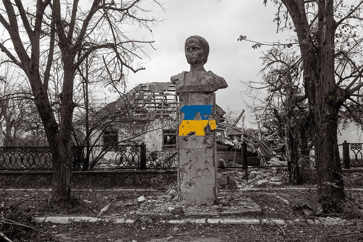 A,Monument,Damaged,By,Shelling,,Against,The,Backdrop,Of,A A monument damaged by shelling, against the backdrop of a destroyed house. War in Ukraine. Russian invasion of Ukraine. Terror of the civilian population. War crimes