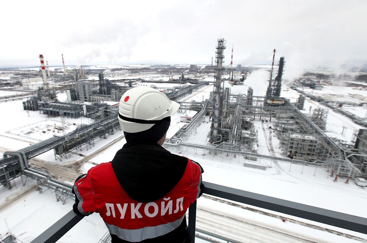 Inside The Lukoil OAO Oil Refinery An employee wears a branded jacket on a platform above the Lukoil-Nizhegorodnefteorgsintez petroleum refinery, operated by OAO Lukoil, in Nizhny Novgorod, Russia, on Thursday, Dec. 15, 2011. Russia, the world's biggest oil producer, may lower its export duty on most crude shipments by 2.2 percent on Jan. 1 after prices fell. Photographer: Andrey Rudakov/Bloomberg via Getty Images