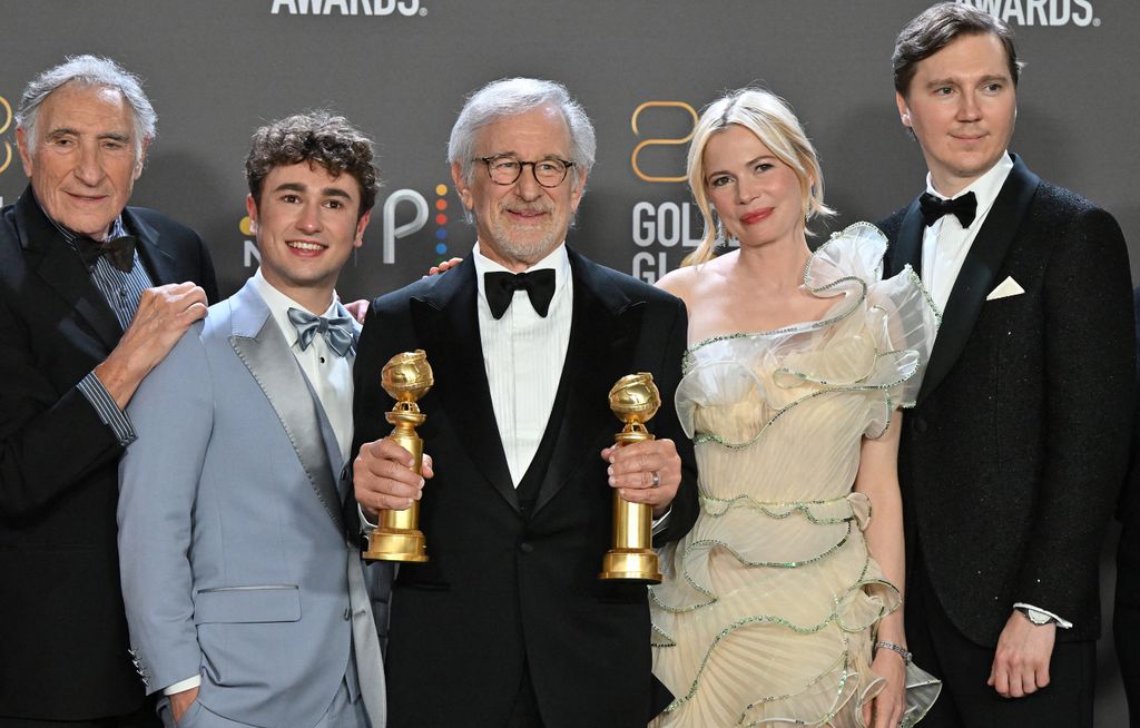 US director Steven Spielberg (C) poses with the awards for Best Director - Motion Picture and Best Picture - Drama for "The Fabelmans" alongside US actor Judd Hirsch (L), Canadian-US actor Gabriel LaBelle (2nd L), US actress Michelle Williams (2nd R) and US actor Paul Dano (R) in the press room during the 80th annual Golden Globe Awards at The Beverly Hilton hotel in Beverly Hills, California, on January 10, 2023. 