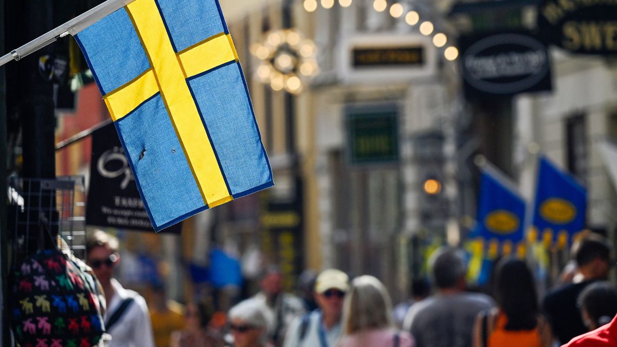 A Swedish national flag hanging from a shop in Gamla Stan in Stockholm, Sweden, on Thursday, Aug. 18, 2022. Swedens government forecast the economic expansion to stall next year as high inflation and rising rates weigh on household consumption. 