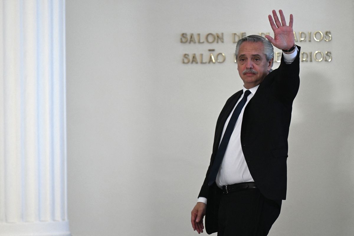 Argentina's President Alberto Fernandez (C) waves while leaving at the end of the Mercosur heads of state summit and associated countries in Montevideo on December 6, 2022.