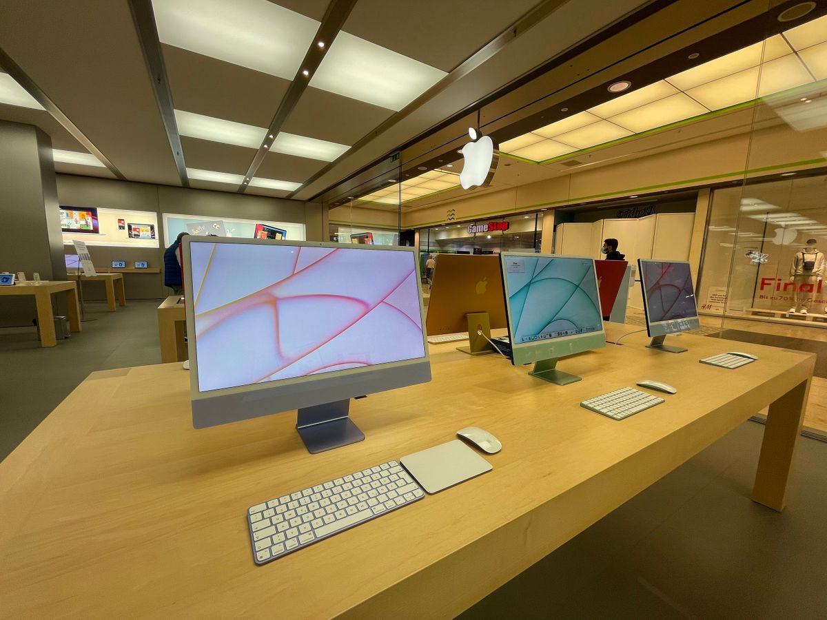 Cologne, Germany - September 02nd 2021: A german photographer visiting an Apple Store in a shopping mall, collecting information and taking pictures of the all new Apple iMac 2021 in different colors.