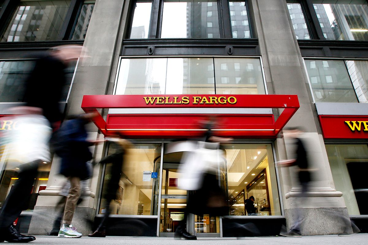 Wells Fargo Agreed Would Pay To Settle With A U.S. Consumer Finance Watchdog NEW YORK, NEW YORK - JANUARY 10: People walk past a Wells Fargo branch on January 10, 2023 in New York City. Wells Fargo agreed the bank would pay $3.7 billion to settle with a U.S. consumer finance watchdog, for years of mistakenly freezing accounts, wrongly repossessing cars and illegally charging customers fees.  (Photo by Leonardo Munoz/VIEWpress)