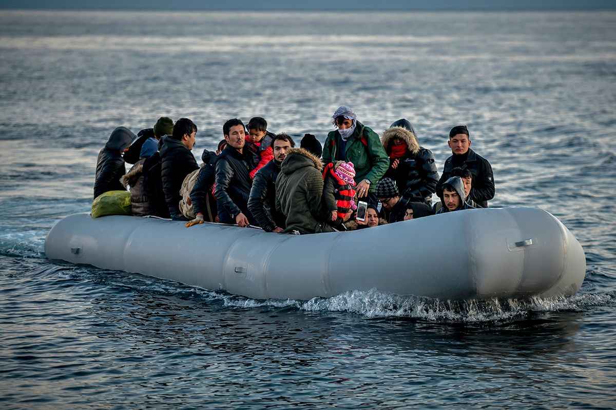 Lesbos,,Greece,,March,2,,2020:,Refugees,And,Migrants,Aboard,Reach Lesbos, Greece, March 2, 2020: Refugees and Migrants aboard reach the Greek Island of Lesbos after crossing on a dinghy the Aegean sea from Turkey