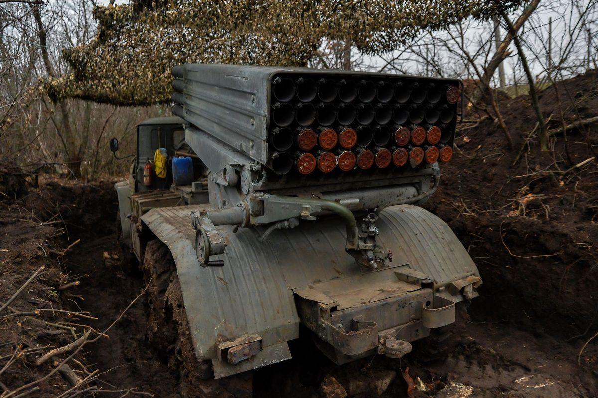 DONETSK REGION, UKRAINE - 2022/12/26: A Ukrainian multiple-launch rocket system is hiding among the trees near Soledar as the fighting in the Donbas region continues. 