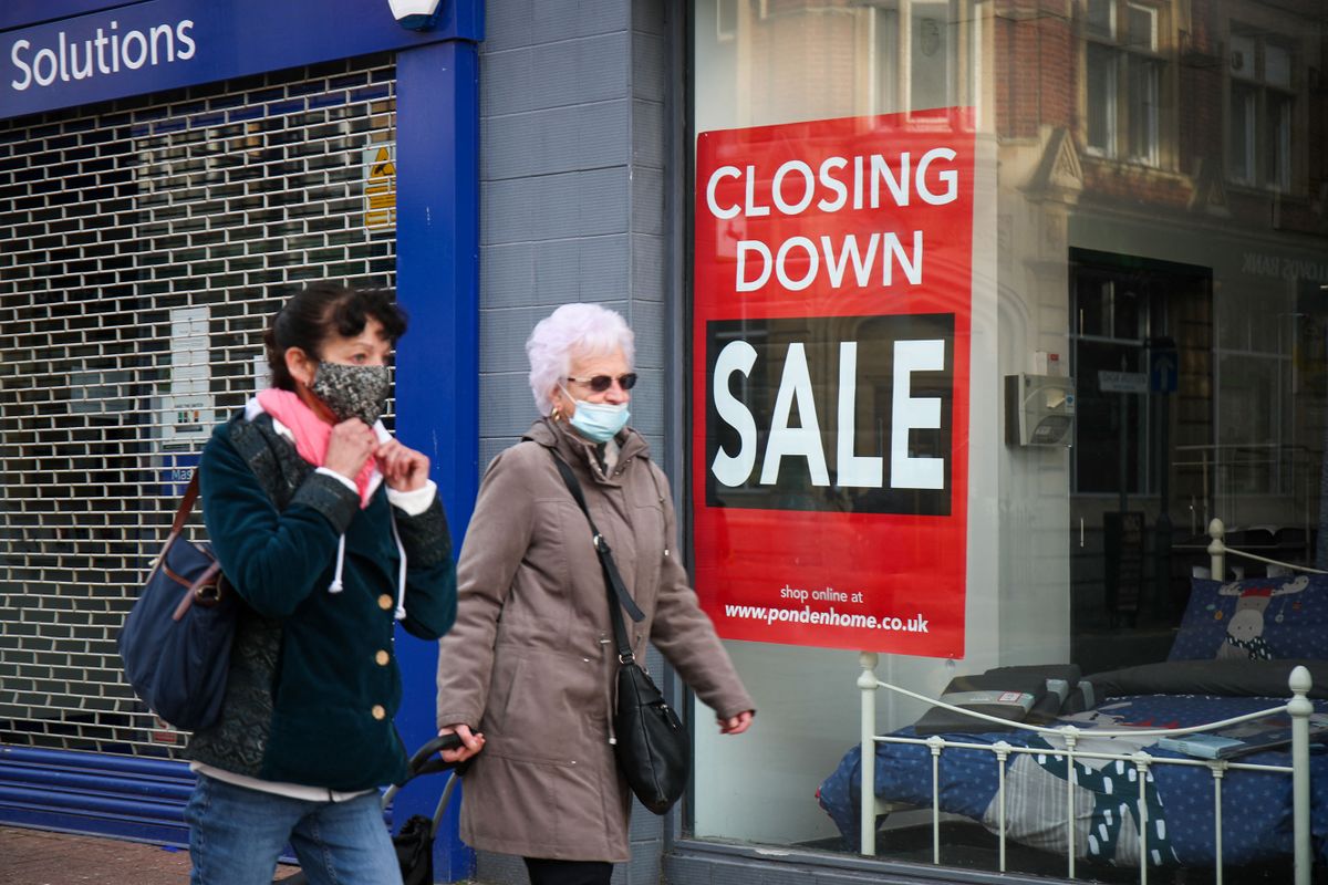 November 20 2020, People walk past a closing store, businesses are closing down blaming the inability to survive the financial impact of national lockdowns and social restrictions during the Covid-19 Pandemic after in England non-essential shops as well as bars, restaurants, gyms and hair salons have been closed as part of the country's second national coronavirus lockdown which begun on November 5th and ends on December 2nd 