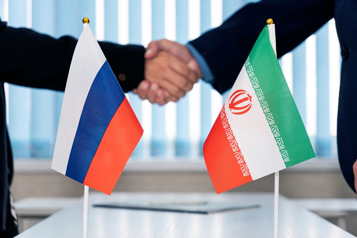 Political flags of russia and iran on table in international negotiation room. concept of negotiations, collaboration and cooperation of countries. agreement between the governments.