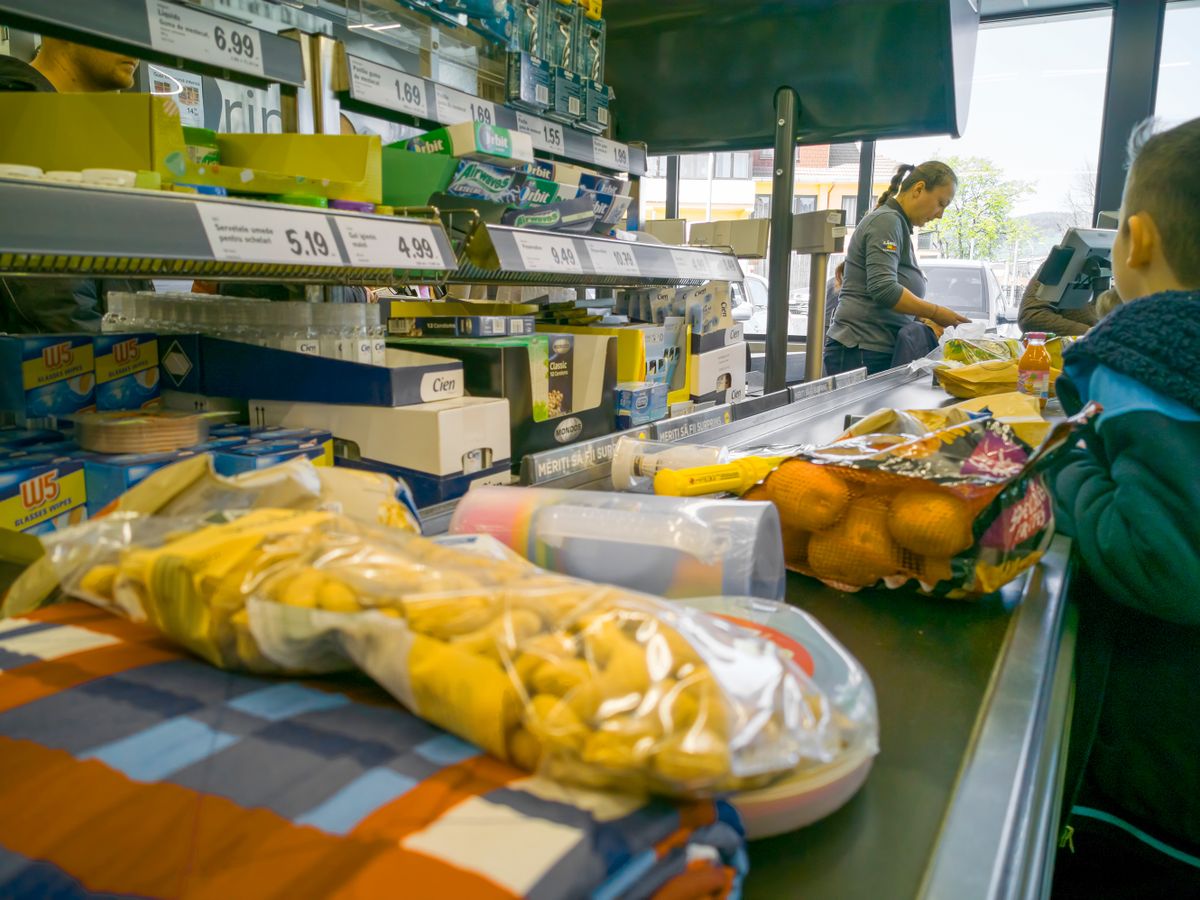 PIATRA NEAMT, ROMANIA - APRIL 25, 2019: Cash desk and products on conveyor belt in Lidl supermarket