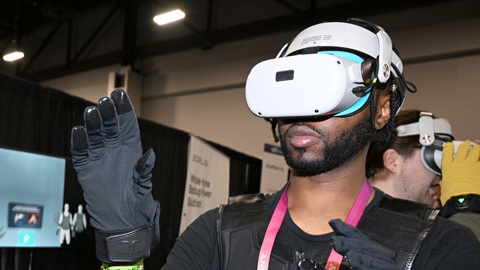 Consumer Electronics Show (CES) 2023
An attendee tests out the bHaptics Inc. haptic gloves and vest for AR/VR gaming at CES Unveiled ahead of the Consumer Electronics Show (CES) on January 3, 2023 in Las Vegas, Nevada. - CES explores next-gen technology in the context of numerous topics, including 5G and IoT, advertising, automotive, block chain, health and wellness, immersive entertainment, robotics and more. 2023 CES will showcase more than 1400 exhibiting companies. (Photo by Robyn BECK / AFP)