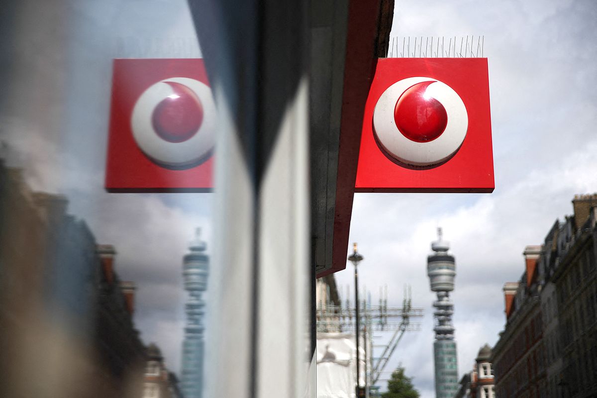 A Vodafone logo is seen at a store in central London on May 16, 2017. - Vodafone logged today a large annual net loss after slashing the value of its troubled Indian division, but underlying earnings soared on a solid European performance. (Photo by Daniel LEAL / AFP)