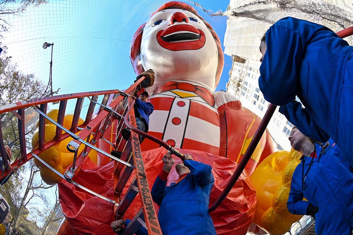 96th Macy's Thanksgiving Day Parade Balloon InflationNEW YORK, NEW YORK - NOVEMBER 22: (EDITORS NOTE: Image captured with a fisheye lens.) The Macy's Inflation Team prepare the Ronald McDonald balloon ahead of the 96th Macy's Thanksgiving Day Parade on the Upper West Side on November 23, 2022 in New York City. Macy's celebrates the 96th Thanksgiving Day Parade with seven new balloons and six new floats, including SInclair Oil's Dino and Baby Dino, Bluey, Baby Shark, The Hottest Heart, Striker the U.S. Soccer Star and Greg Heffley of "Diary of a Wimpy Kid." (Photo by Alexi Rosenfeld/Getty Images)