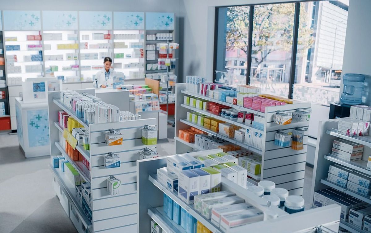 Big,Modern,Pharmacy,Drugstore,With,Shelves,Full,Of,Packages,Full Big Modern Pharmacy Drugstore with Shelves full of Packages Full of Modern Medicine, Drugs, Vitamin Boxes, Pills, Supplements, Health Care Products. Pharmacist Standing at Counter., gyógyszertár, patika, gyógyszer, pills, drugs, pharmacy, gyógyszeripar