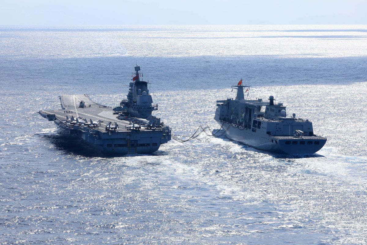 (211231) -- BEIJING, Dec. 31, 2021 (Xinhua) -- Undated file photo shows the Chinese navy's Liaoning (L) aircraft-carrier receiving supplies during open-sea combat training. The Chinese navy's Liaoning aircraft-carrier formation returned on Dec. 30, 2021 to a military port in Qingdao, east China's Shandong Province, concluding 20-plus days of open-sea combat training.   The exercise, which began on Dec. 9, took the formation into various waters, from the Yellow Sea to the East China Sea and the West Pacific, and has improved the formation's combat capability, according to an official statement. (Photo by ) 