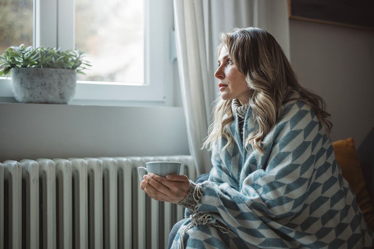 Unwell woman feel cold in home with no heating