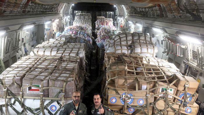 Kuwaiti army soldiers pose inside a military plane carrying humanitarian aid for Turkey following a deadly earthquake, at Kuwait international airport in Kuwait City, on February 9, 2023. - A 7.8-magnitude earthquake hit Turkey and Syria on February 6, killing more than 16,000 people and injuring tens of thousands of people. Thousands of homes were destroyed on both sides of the border after the tremor and the subsequent aftershocks. (Photo by YASSER AL-ZAYYAT / AFP)