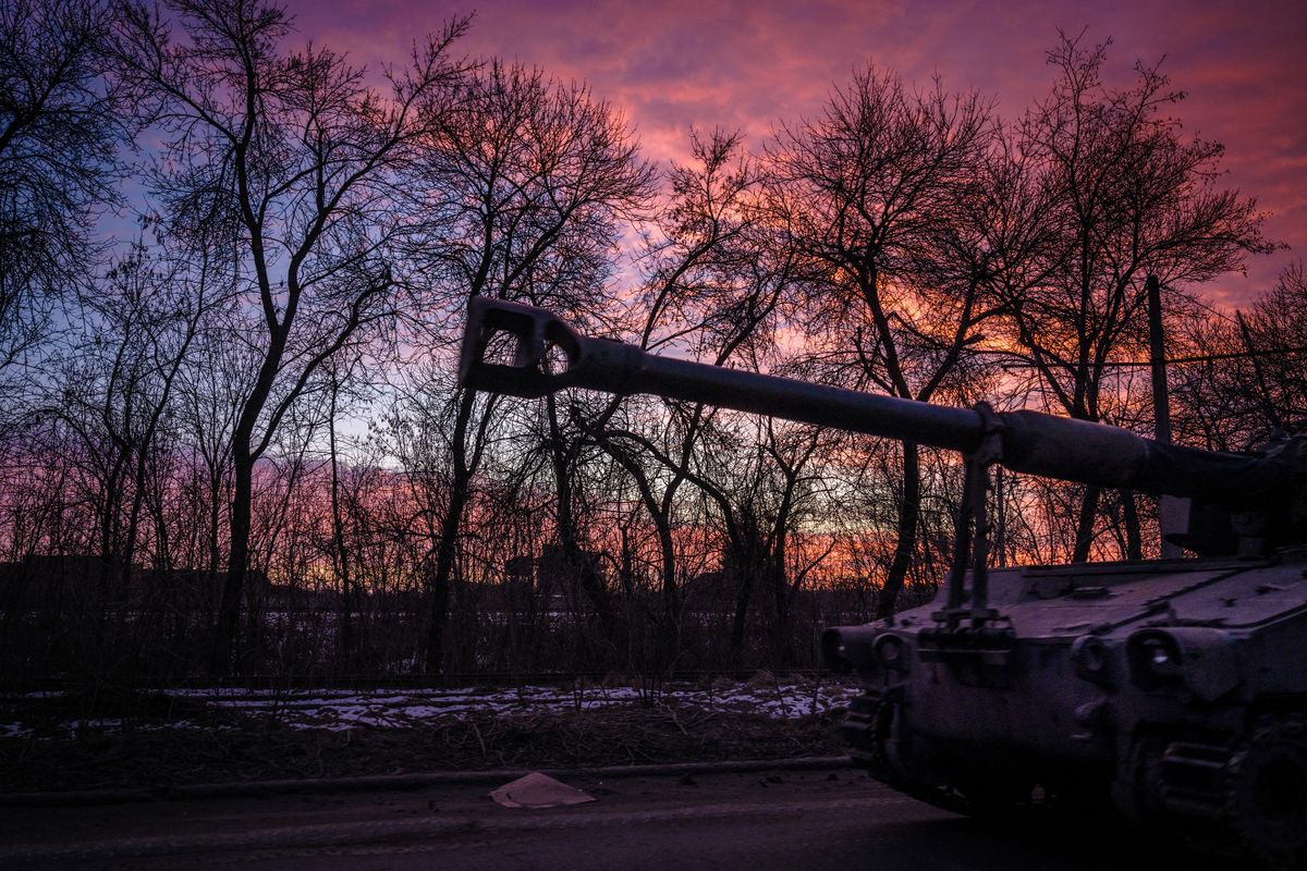 A Ukrainian self-propelled howitzer runs at sunset in the Donetsk region on February 9, 2023, amid the Russian invasion of Ukraine. 