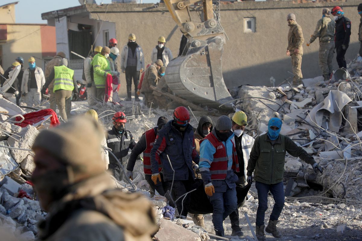 Rescuers evacuate a body in Nurdagi, near Gaziantep, on February 13, 2023, as rescue teams began to wind down the search for survivors, a week after an earthquake devastated parts of Turkey and Syria leaving more than 35,000 dead and millions in dire need of aid. 