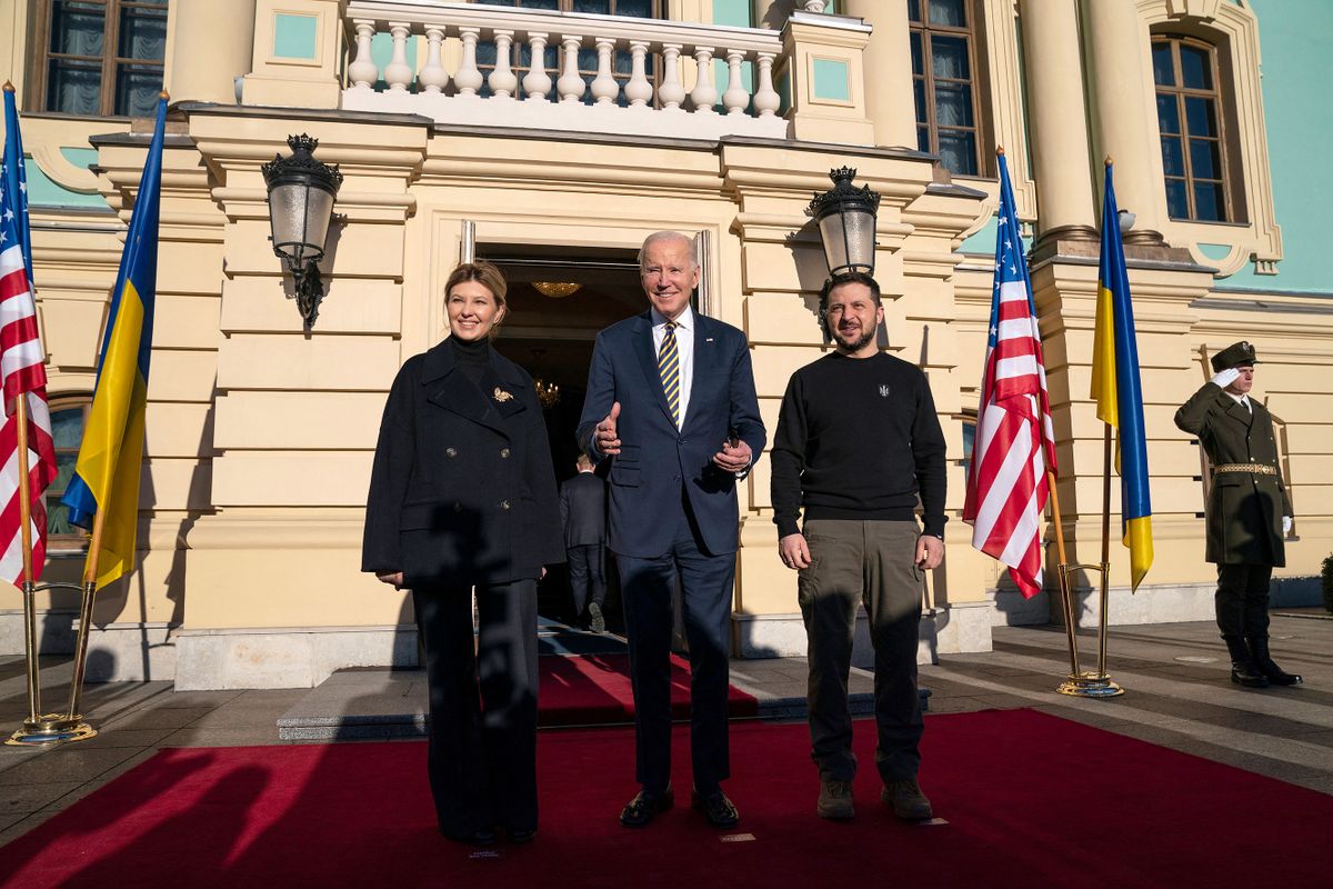President Joe Biden (C) reacts as he poses for a photograph with Ukrainian President Volodymyr Zelensky and his wife Olena Zelenska, upon his arrival at the Mariinsky Palace in Kyiv on February 20, 2023. - US President Joe Biden promised increased arms deliveries for Ukraine during a surprise visit to Kyiv on February 20, 2023, in which he also vowed Washington's "unflagging commitment" in defending Ukraine's territorial integrity.