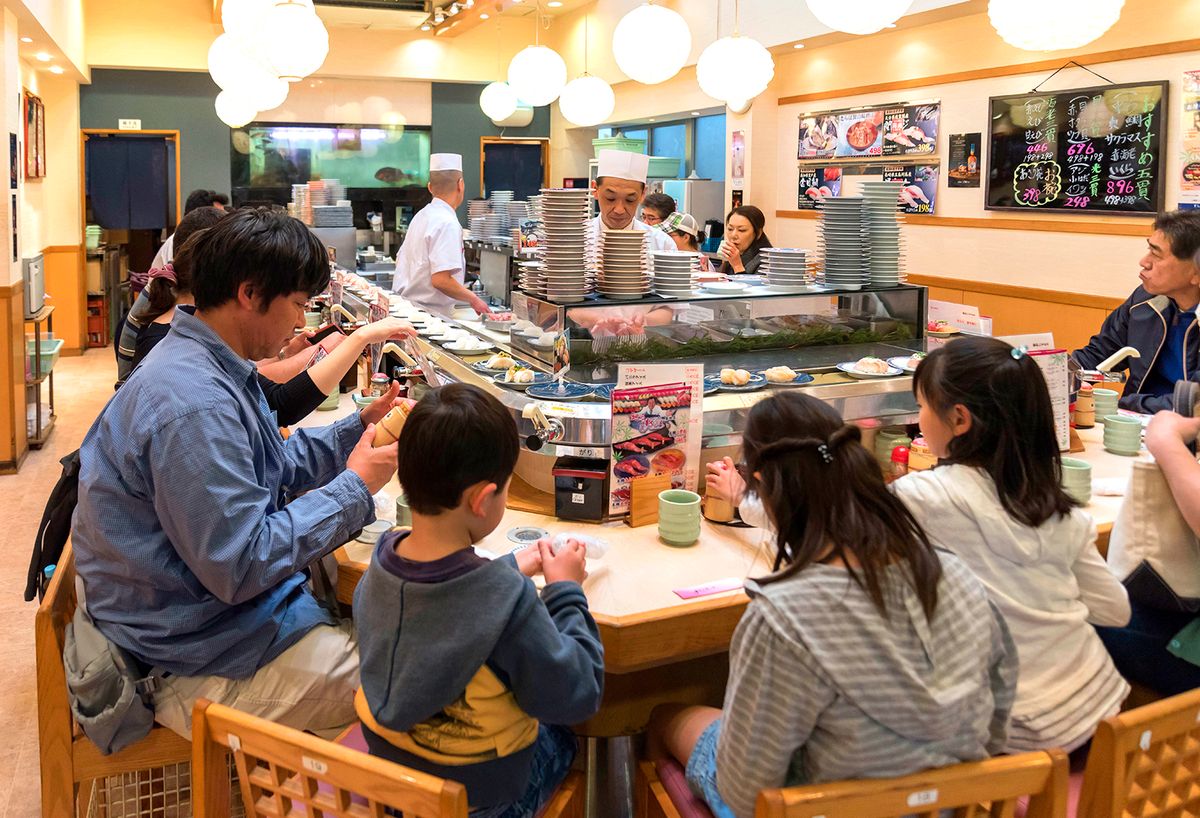 Conveyor belt sushi, Tsukiji market Kaiten-zushi restaurant serving sushi on rotating conveyor belt, Tsukiji fish market, Tokyo, Japan. (Photo by: Education Images/Universal Images Group via Getty Images)