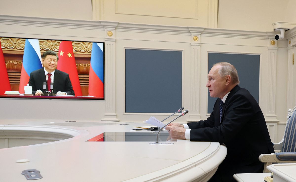 Russian President Vladimir Putin holds a meeting with Chinese President Xi Jinping via a video link at the Kremlin in Moscow on December 30, 2022. - Russian leader told his Chinese counterpart on December 30 he was keen to ramp up military cooperation and hailed the two countries' efforts to counter Western influence. 