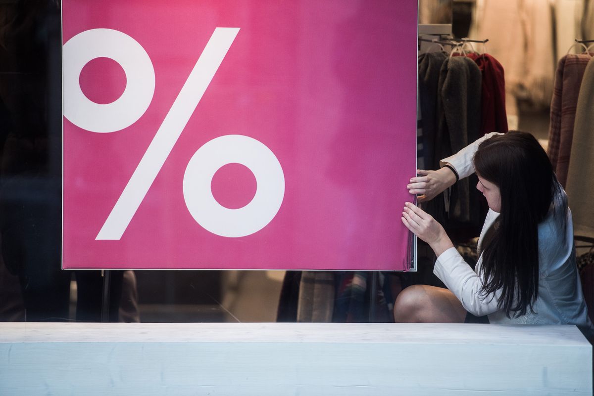 An employee adjusts a sale sign in the window of a fashion retailer in Budapest, Hungary, on Tuesday, Dec. 27, 2016. Hungarian retail sales rose at the slowest pace since the start of the year in October, casting doubt on cabinet projections that a fourth-quarter upswing will lift economic growth to thefash
