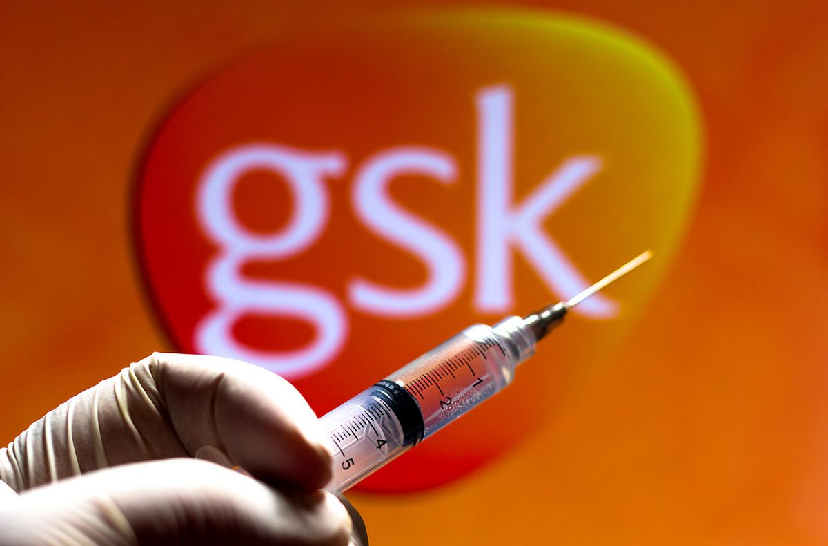 November,20,,2020,,Brazil.,In,This,Photo,Illustration,The,Medical November 20, 2020, Brazil. In this photo illustration the medical syringe (coronavirus vaccine) is seen with GlaxoSmithKline (GSK) company logo displayed on a screen in the background