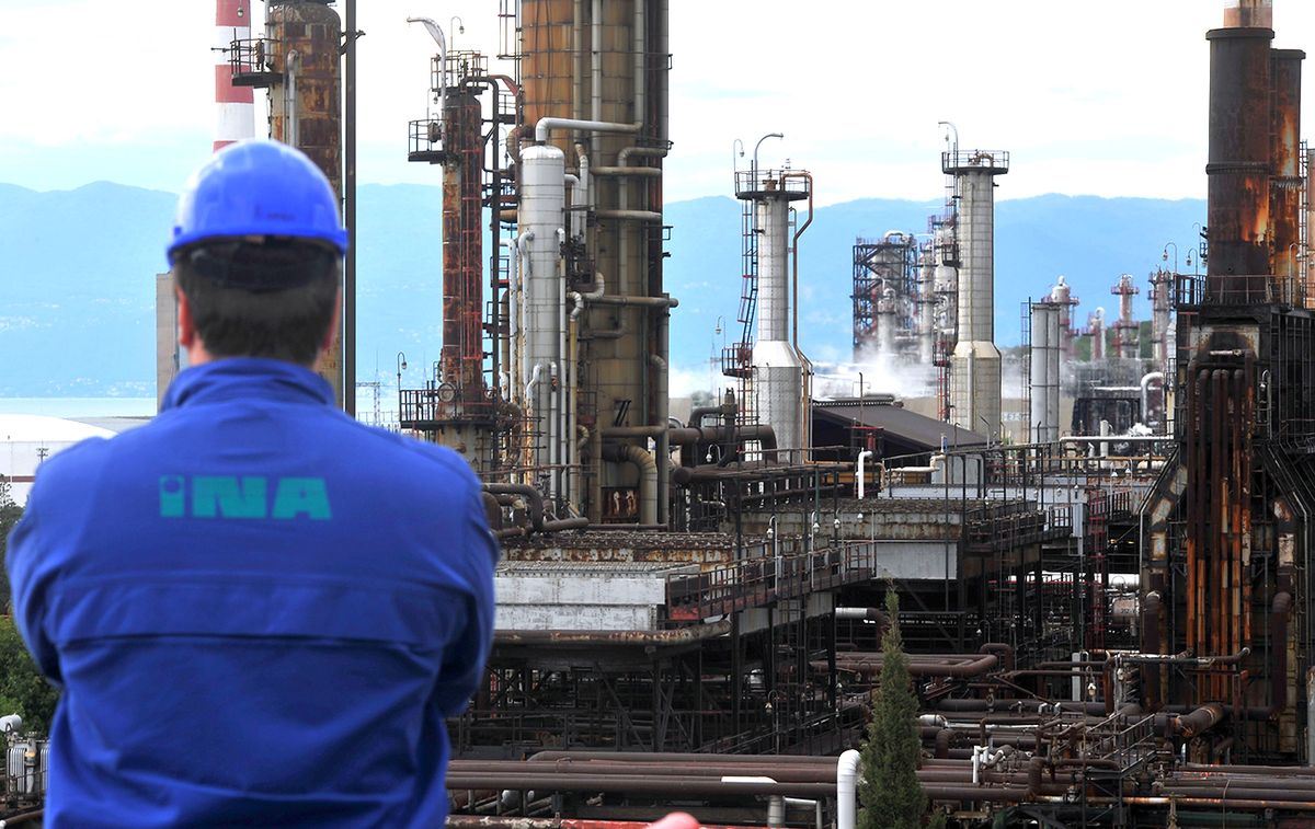 Operations Inside Croatia's INA Industrija Nafte d.d. Oil Refinery And Gas Stations An employee looks towards refining towers at the INA Industrije Nafte d.d. oil refinery on the shores of the Adriatic sea in Urinj, near Rijeka, Croatia, on Thursday, May 23, 2013. Croatia, whose economic development was stifled by Europe's bloodiest fighting since World War II, is trying to revive growth after four years of recession or stagnation. Photographer: Oliver Bunic/Bloomberg via Getty Images