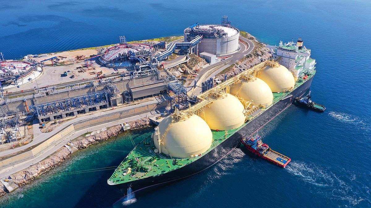 Aerial,Drone,Photo,Of,Lng,(liquified,Natural,Gas),Tanker,Anchored Aerial drone photo of LNG (Liquified Natural Gas) tanker anchored in small gas terminal island with tanks for storage
