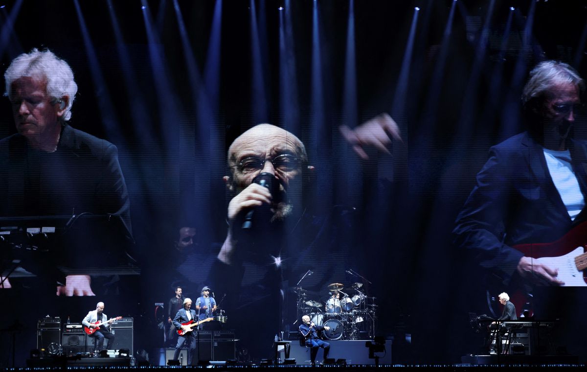 British singer Phil Collins (C) performs on stage during "The last domino" tour of the British rock band Genesis with English musicians and partners Tony Banks (L) and Mike Rutherford (R), at the Paris La Defense Arena, in Nanterre, northeastern France, on March 16, 2022.
