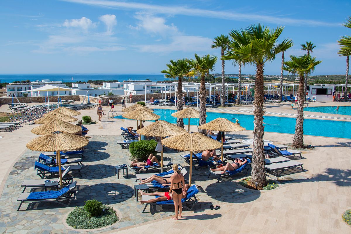 RHODES, GREECE - JUNE 28: Tourists spend their vacation at the swimming pools in the Tui Magic Life Club on Plimmiri Beach with sailing boats, noisy jet skies,  on June 28, 2015 in Kattavia, Rhodes, Dodecanes, Greece. 