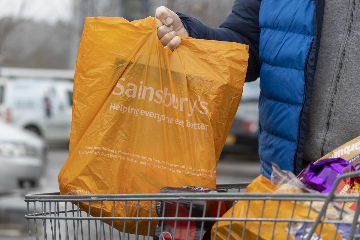 A shopper removes bags from a trolley outside a J Sainsbury Plc supermarket in Godalming, UK, on Tuesday, Jan. 10, 2023. Sainsbury's are due to release a trading update on Wednesday. 