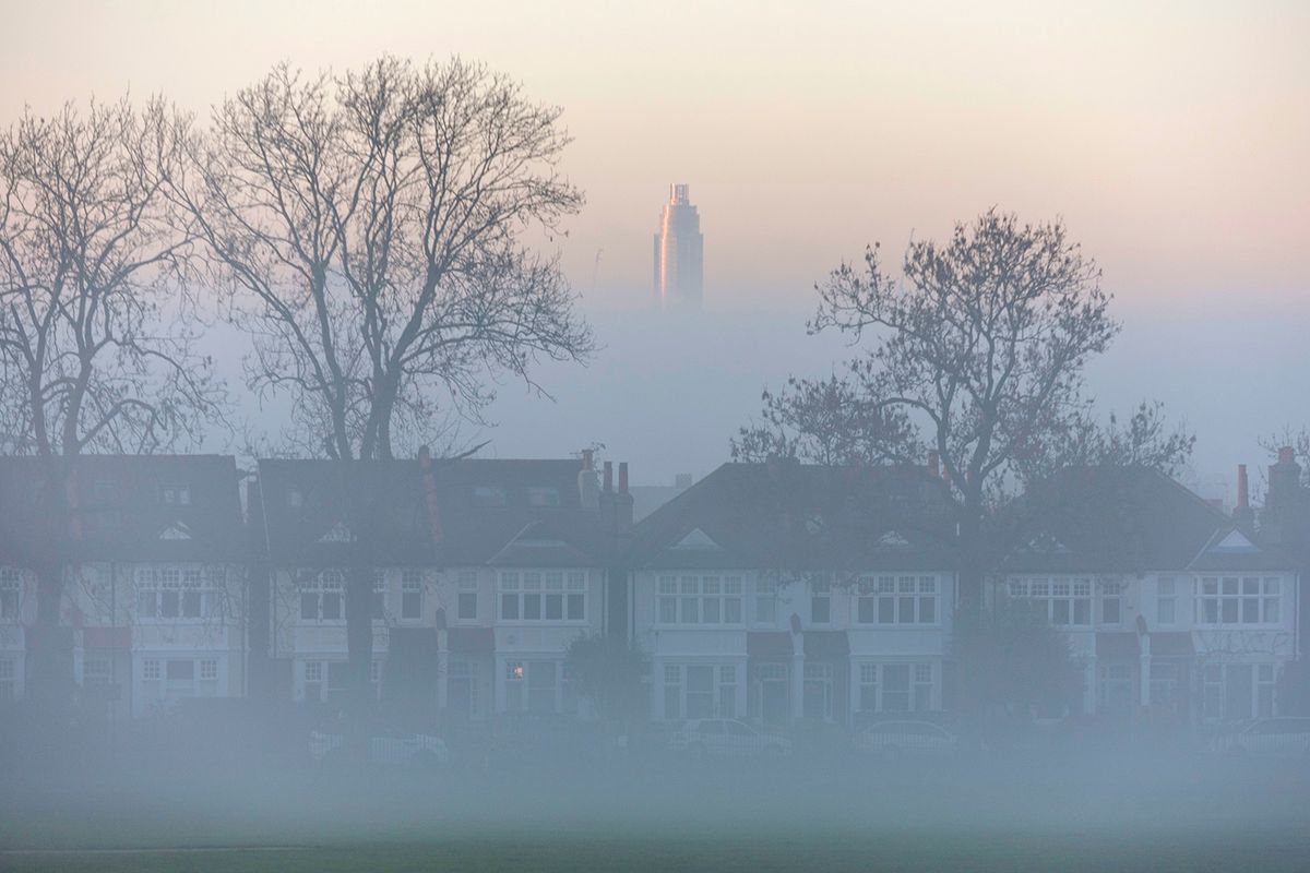 Tower Rising Above Misty Homes Residential skyscraper St George Wharf Tower, miles away in Vauxhall, rises above Edwardian-era tenement homes on Herne Hill, south London, on December 28, 2016, in England.  At 181 meters (594 ft) high and with 49 floors, the tower is the tallest residential building in the United Kingdom.  (Photo by Richard Baker/Photo via Getty Images)